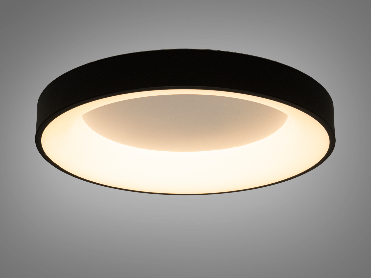 Круглий світильник з теплим білим світлом, чорний корпус. Підходить для створення затишної атмосфери в спальні або вітальні.