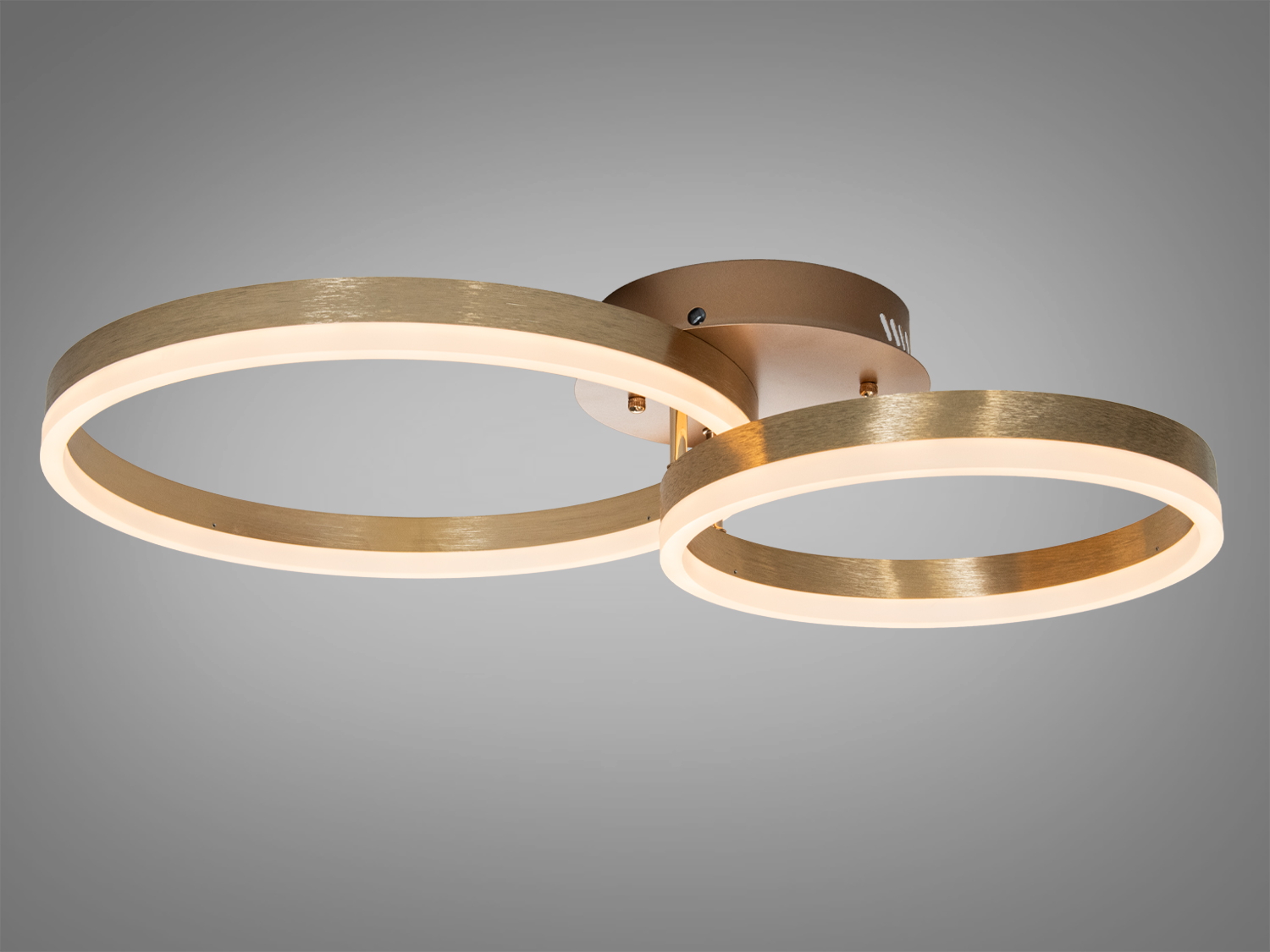 Стельовий світильник з двома паралельними кільцями, виконаний у золотистому відтінку, забезпечує рівномірне освітлення.