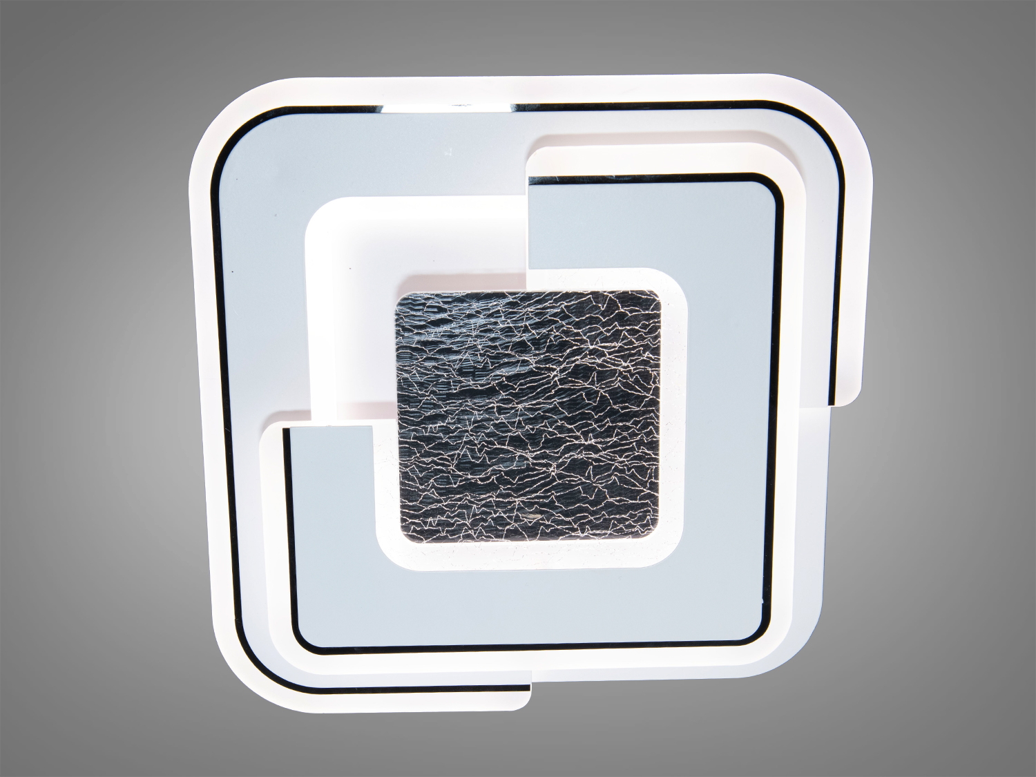 Квадратний світильник з чорними лініями та текстурованим центром, виконаний у мінімалістичному стилі, ідеальний для офісних приміщень.