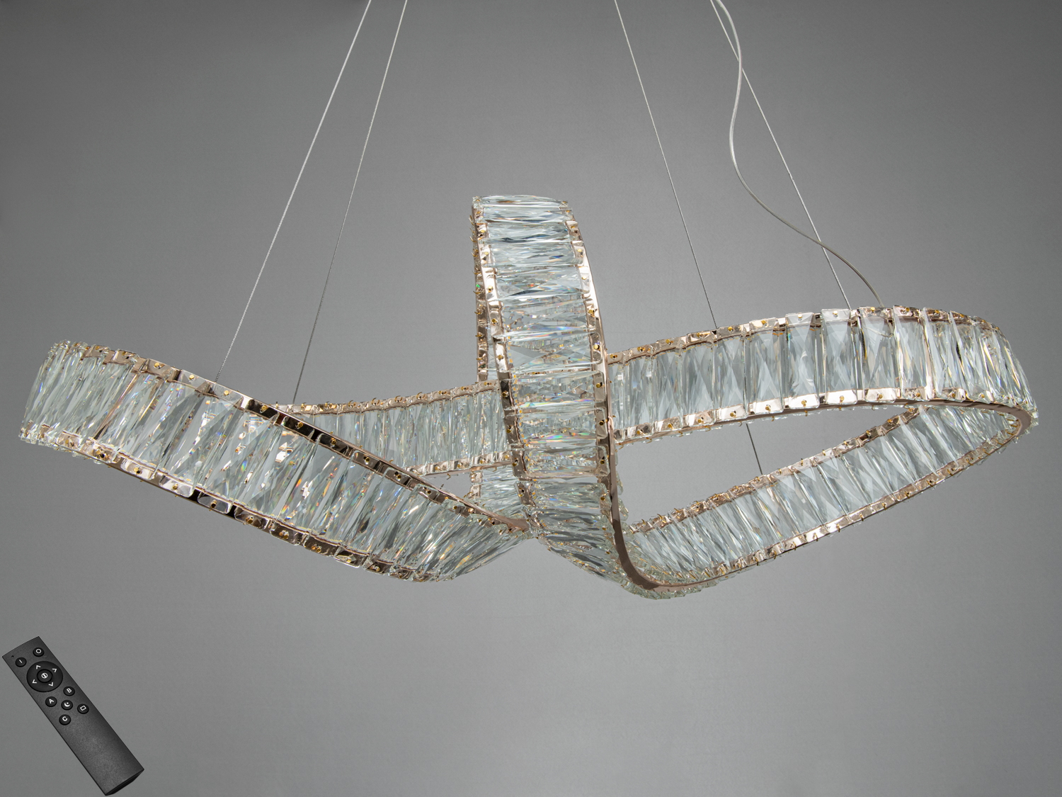 Підвісна люстра з дистанційним керуванням, кришталеві елементи в формі переплетених кілець. Ідеальна для вітальні.