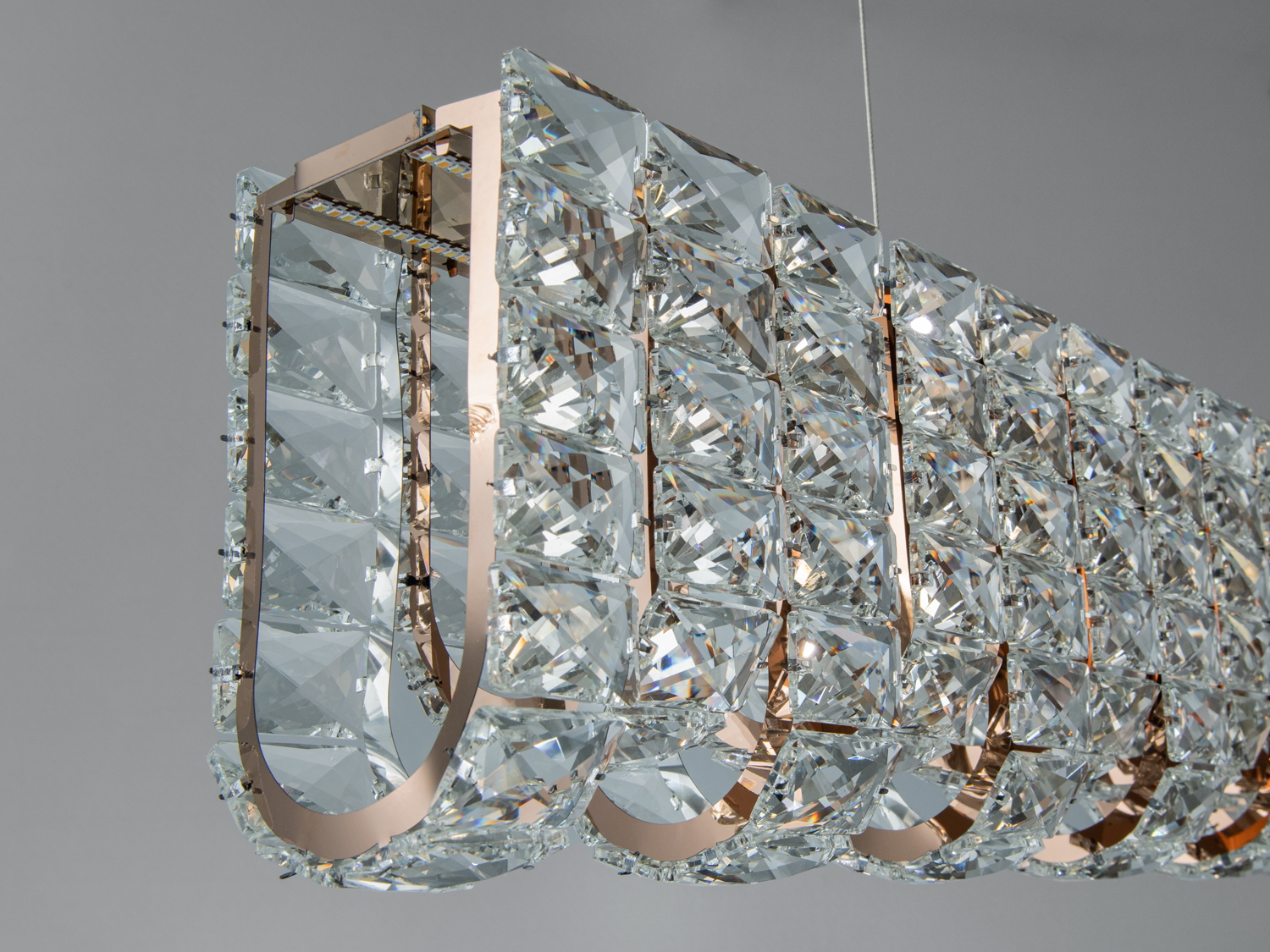 Крупний план підвісної люстри з кришталевими елементами, U-подібний дизайн, підходить для елегантних інтер’єрів.