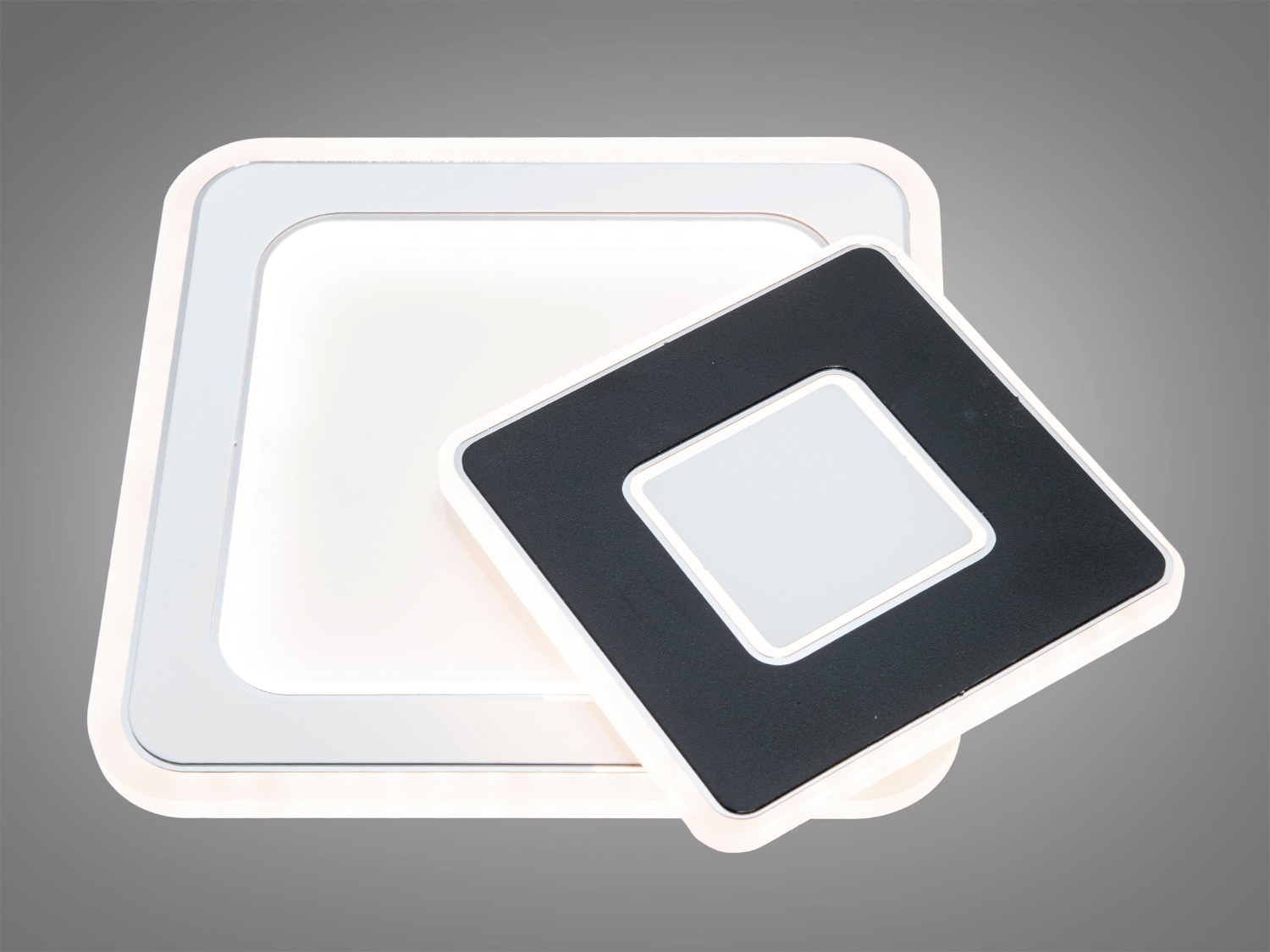 Стельовий світильник квадратної форми з контрастними чорними і білими елементами, забезпечує рівномірне освітлення.