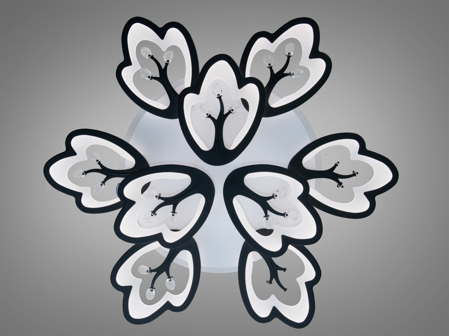 Стельовий світильник з білим підсвічуванням у формі квітки, чорні контури підкреслюють стильний дизайн.