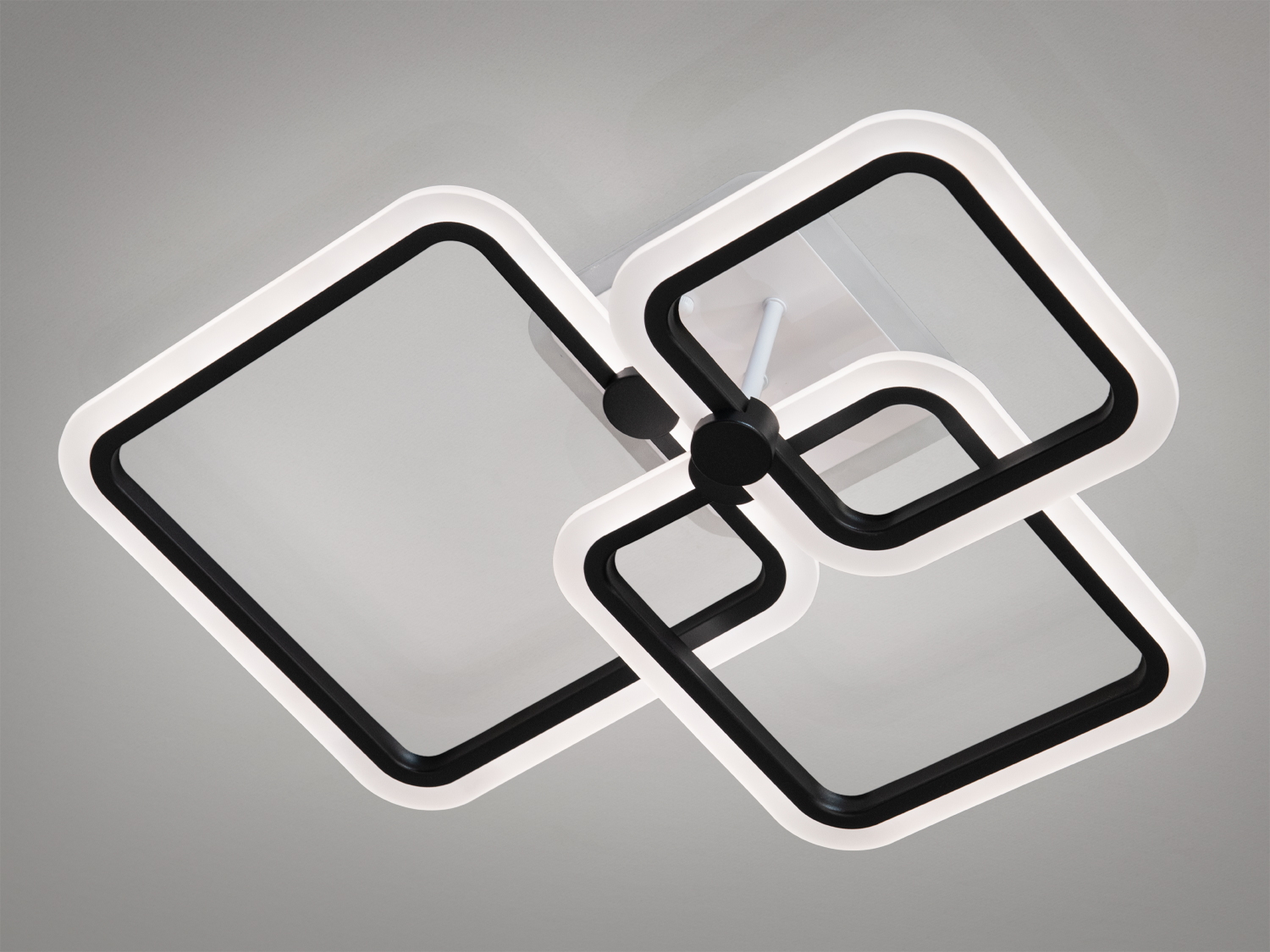 Стельовий світильник з двома квадратними рамками, що світяться білим світлом. Ідеальний для мінімалістичного дизайну.