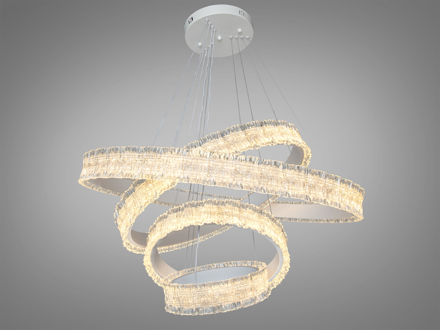 Підвісна люстра з кільцями, що переплітаються, з теплого білого світла. Підходить для сучасних інтер’єрів.