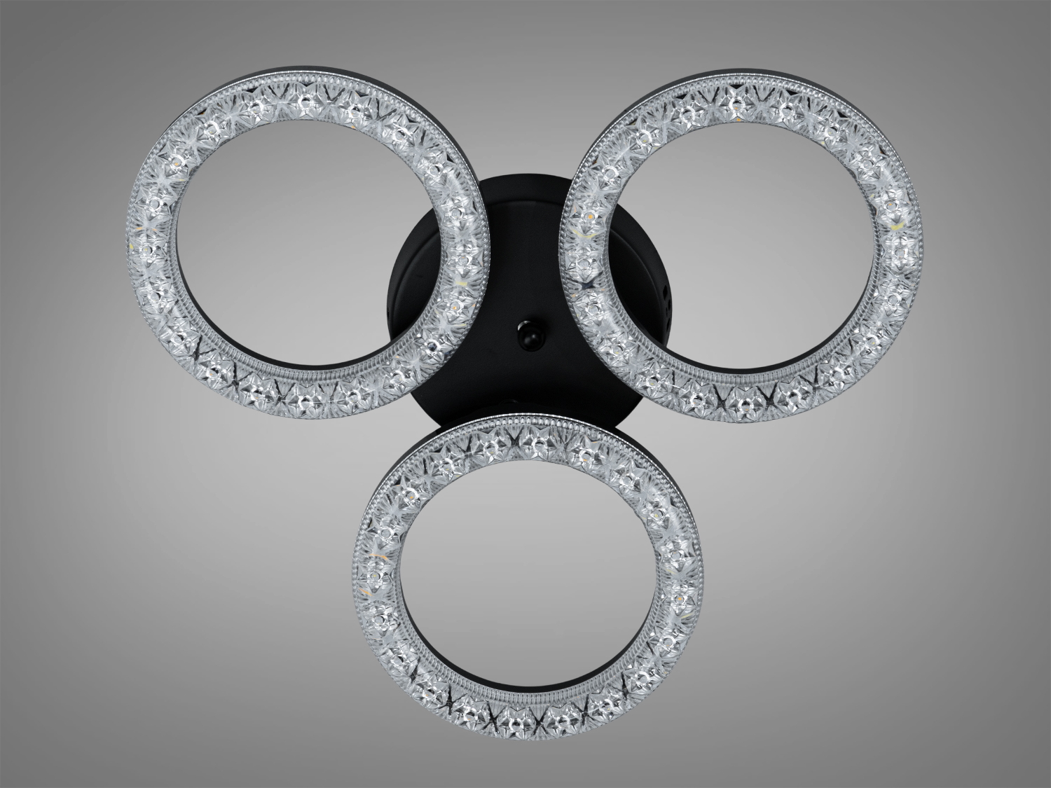 Світильник з трьома кришталевими кільцями на чорній основі. Використовується для стельового монтажу, підходить для сучасного інтер’єру.