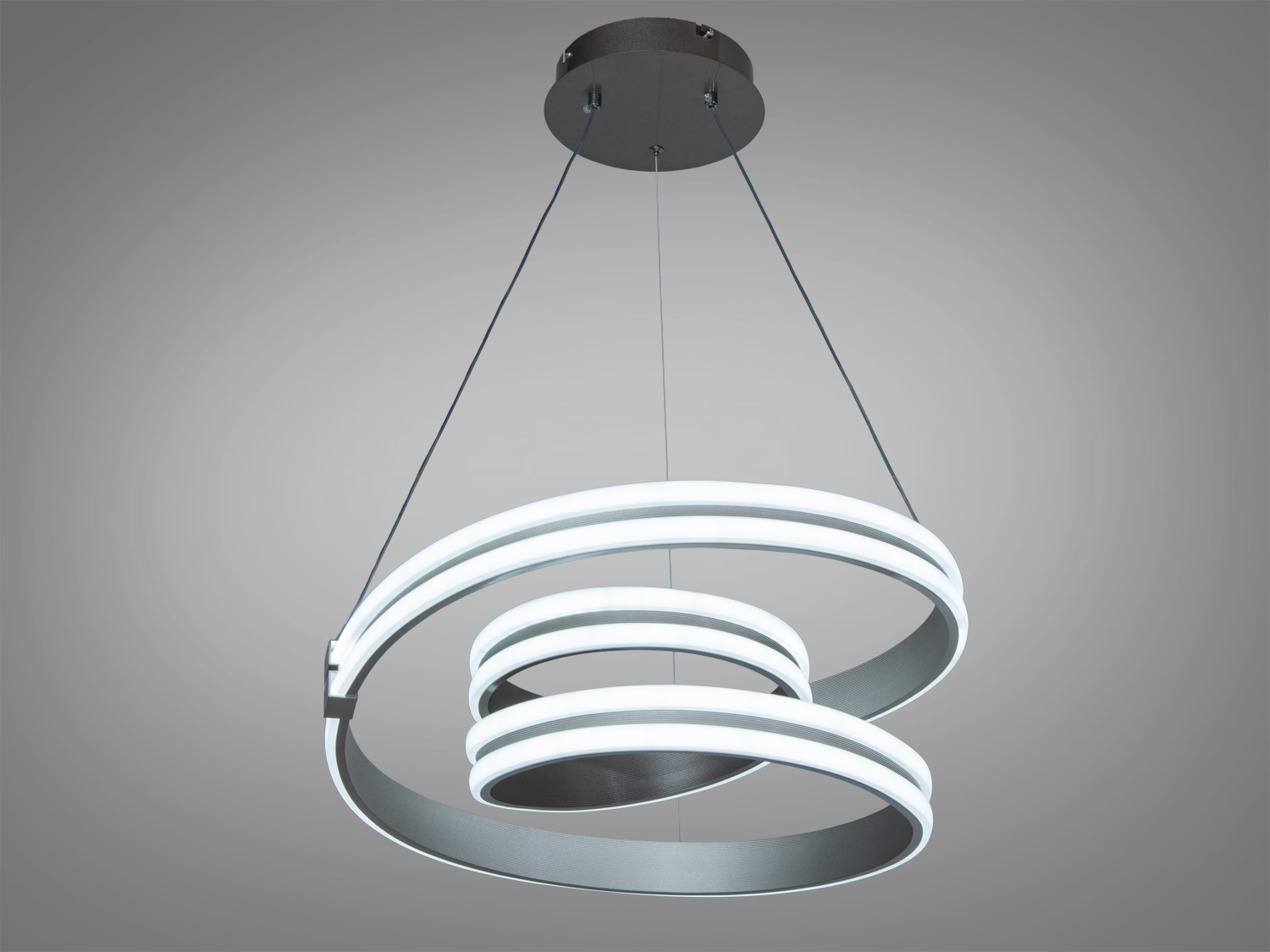 Світильник у формі подвійної спіралі з холодним світлом, підвішений на тонких тросах. Підходить для офісних приміщень.