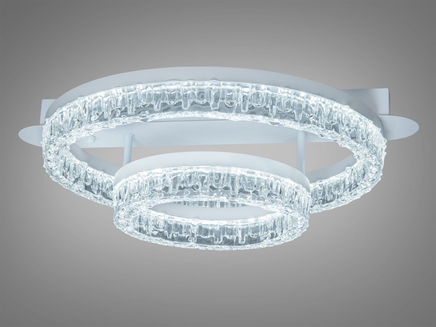 Світильник з прозорими кільцями, що випромінюють холодне світло, підходить для інтер’єрів у стилі хай-тек.