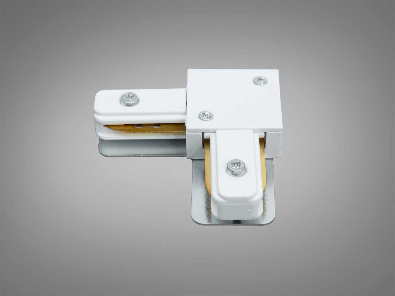 Білий кутовий з′єднувач для трекових світильників, призначений для монтажу в інтер′єрі, з металевими деталями та гвинтовим кріпленням.