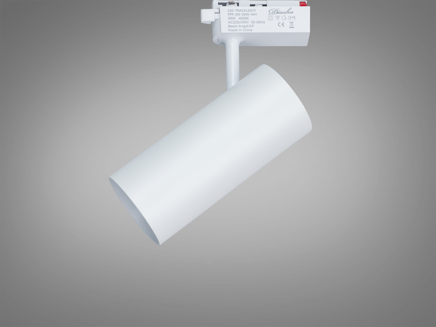 Циліндричний світильник на треку з маркуванням на корпусі, призначений для точкового освітлення в інтер′єрі.