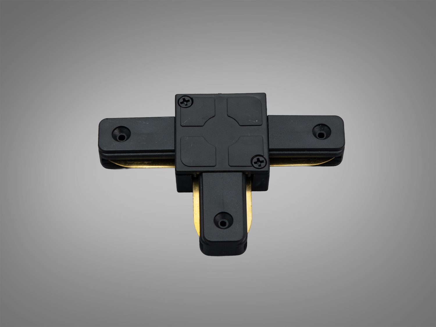 Чорний Т-подібний конектор серії 1003 для трекової системи 220 В. Формує Т-з’єднання, має отвори для монтажу на стелю або стіну, підходить для зонування світла.