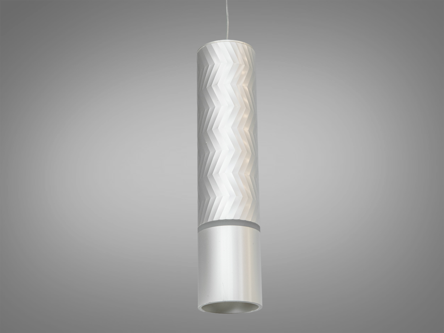 Підвісний світильник з гладкою поверхнею, циліндричний дизайн з хвилястим візерунком. Призначений для віталень.