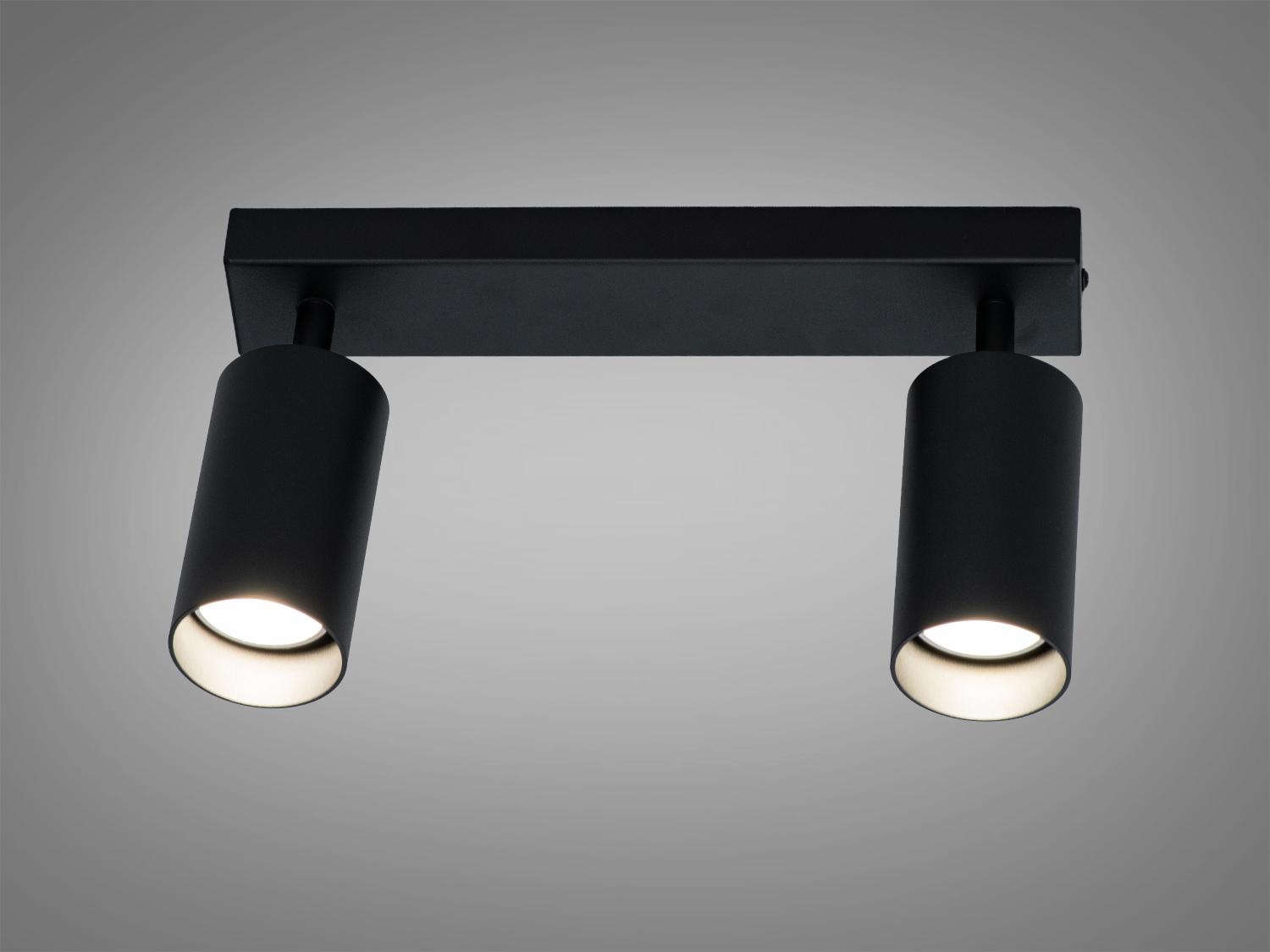 Чорний стельовий світильник з двома лампами, циліндрична форма, ідеальний для мінімалістичного дизайну.