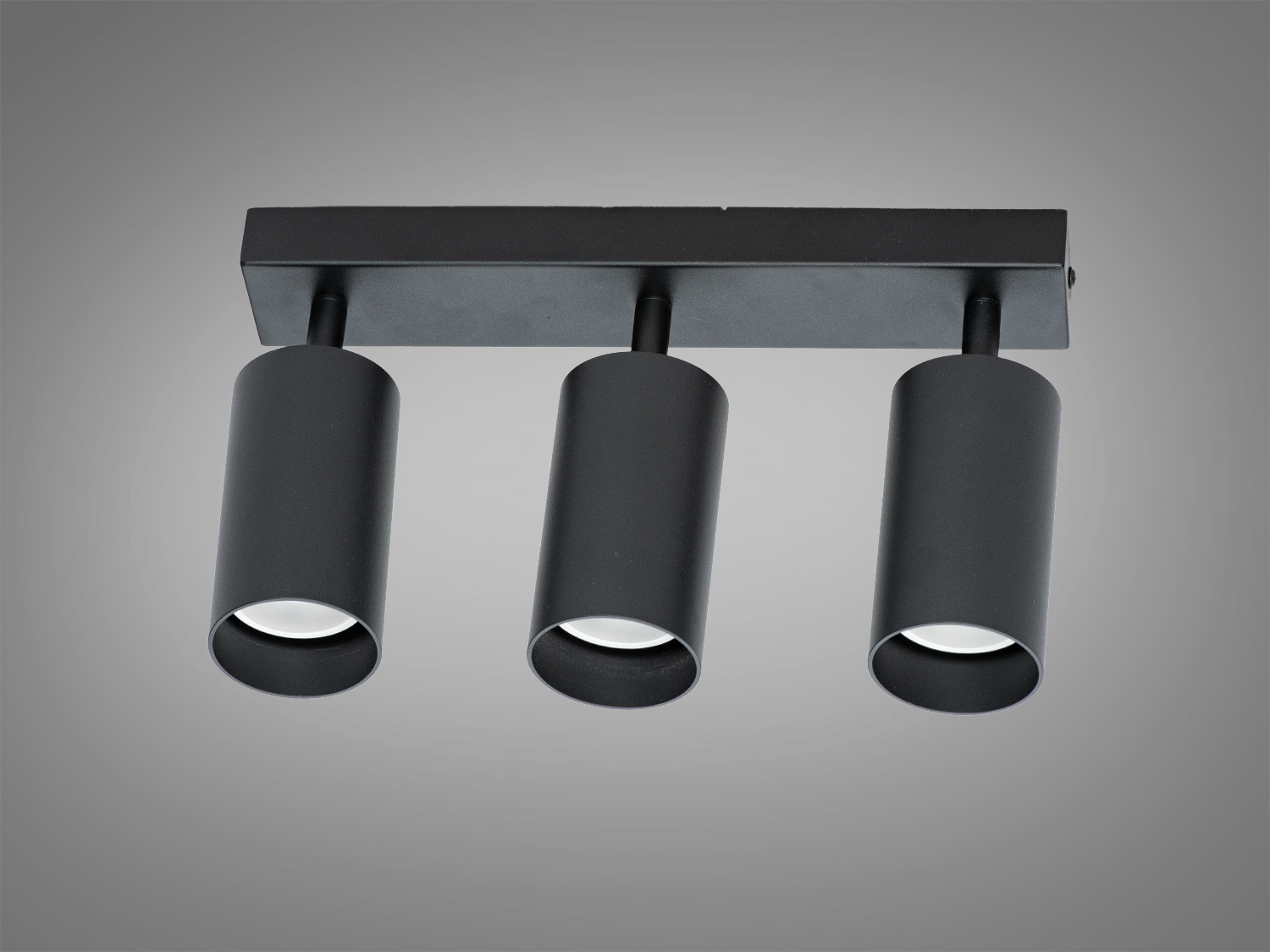 Чорні циліндричні світильники на прямокутній основі, фіксовані в одному напрямку, підходять для сучасних інтер′єрів.